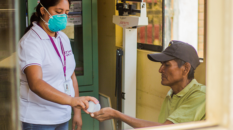 Diego (right), a patient with TB taking part in the endTB project, receives treatment from Yecela Rodríguez, a field technician at the Punchauca Health Center in Carabayllo, Peru. 
