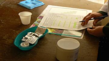 MSF medical staff in Armenia review a patient's extensive drug prescription. (Andrea Bussotti/MSF)