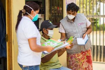 Diego (center, name changed) receives advice from PIH community health worker Verónica Quispe and PIH nursing technician Yecela Rodríguez at the Punchauca Health Center in Carabayllo, Peru. (William Castro Rodríguez / Socios En Salud)