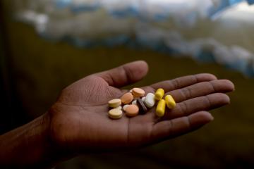 Patient holding his medication, he takes up to 26 pills a day to treat XDR-TB. Here he holds his morning selection, which includes delamanid, one of the newest DR-TB drugs, which he is taking for the first time today.